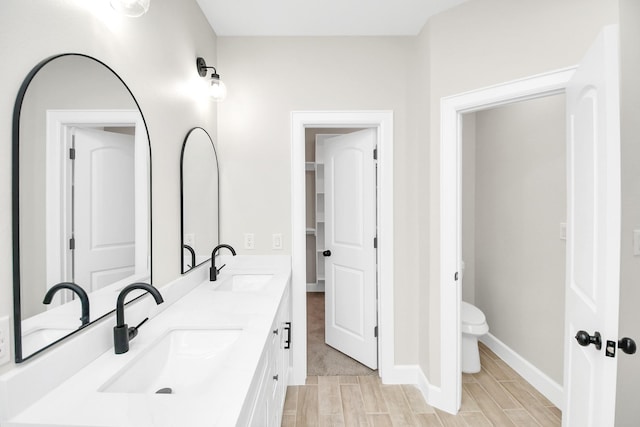 bathroom with hardwood / wood-style floors, vanity, and toilet