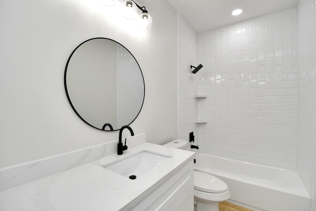 full bathroom featuring vanity, toilet, and tiled shower / bath