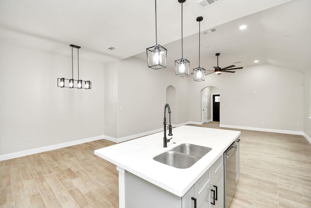 kitchen with pendant lighting, dishwasher, a kitchen island with sink, sink, and ceiling fan