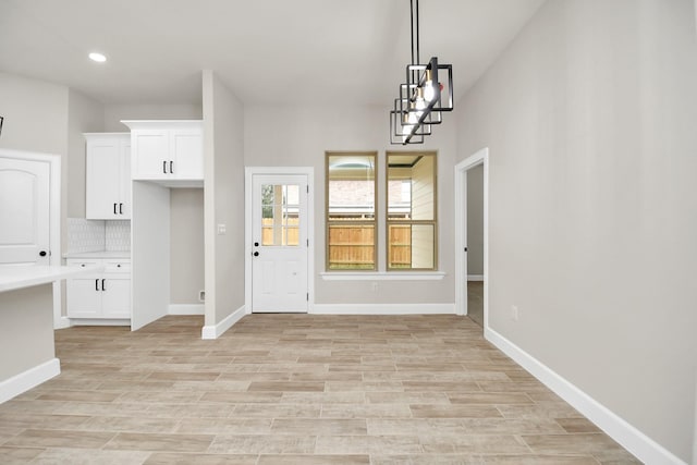 interior space featuring light hardwood / wood-style floors and an inviting chandelier