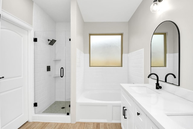 bathroom with wood-type flooring, vanity, and separate shower and tub