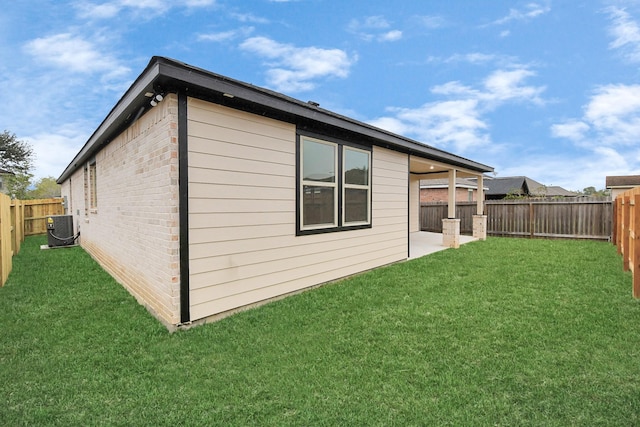 view of home's exterior featuring central AC unit, a patio area, and a lawn