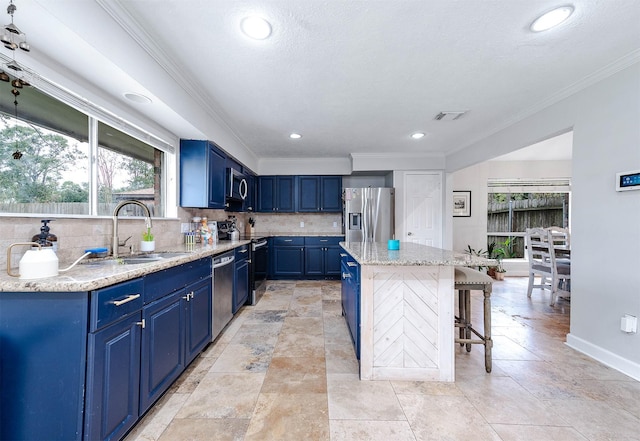 kitchen featuring blue cabinetry, a kitchen bar, a center island, and stainless steel appliances