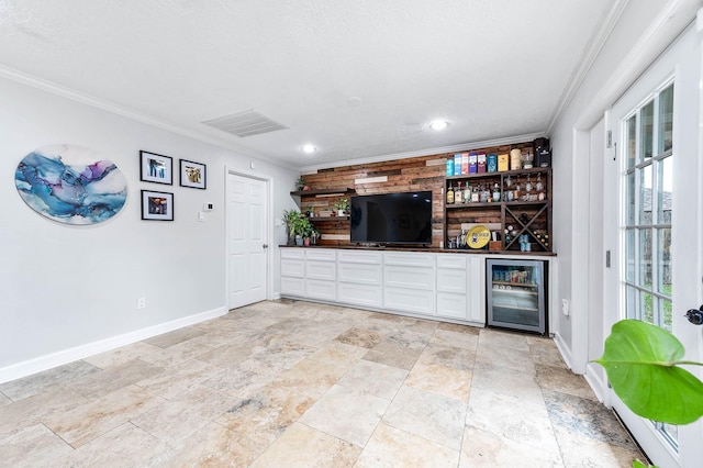 bar with white cabinets, crown molding, and beverage cooler