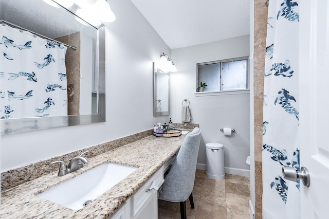 bathroom featuring a shower with curtain, vanity, and toilet