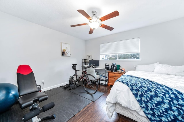 bedroom with dark hardwood / wood-style floors and ceiling fan