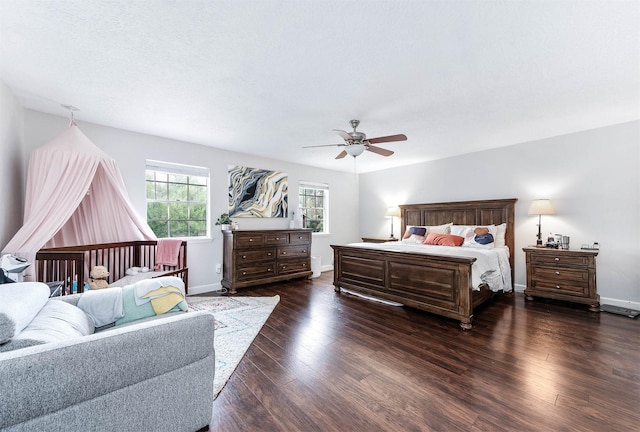 bedroom with dark hardwood / wood-style flooring and ceiling fan