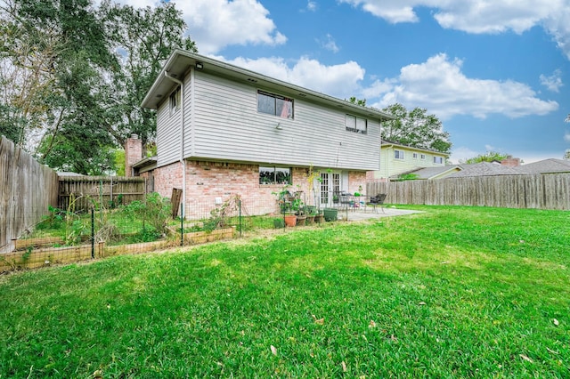 back of property with a yard and a patio