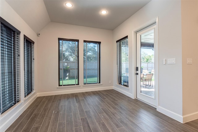 interior space featuring vaulted ceiling and dark hardwood / wood-style floors