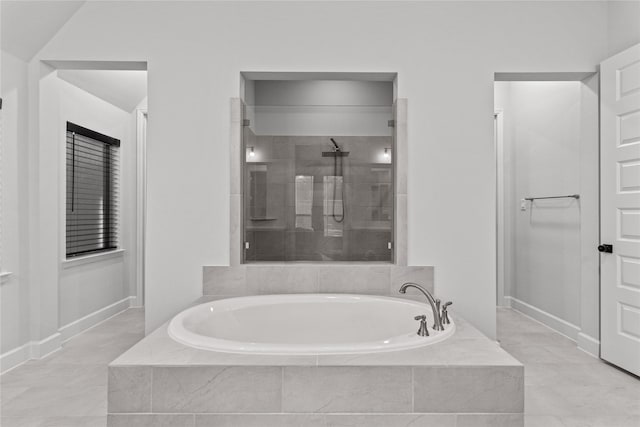 bathroom featuring separate shower and tub