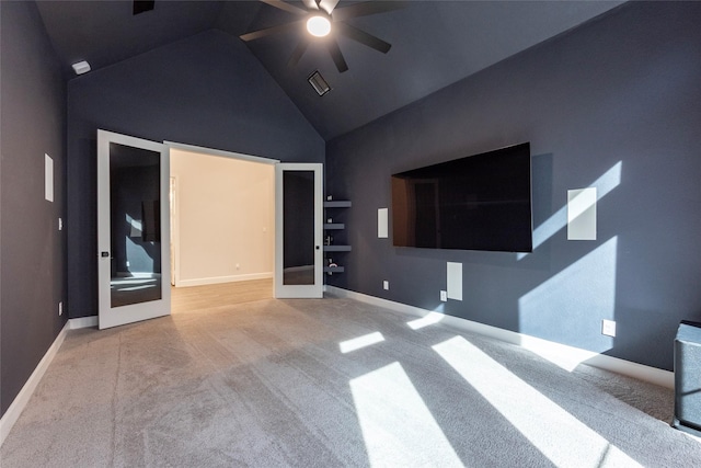 unfurnished living room with carpet, french doors, high vaulted ceiling, and ceiling fan