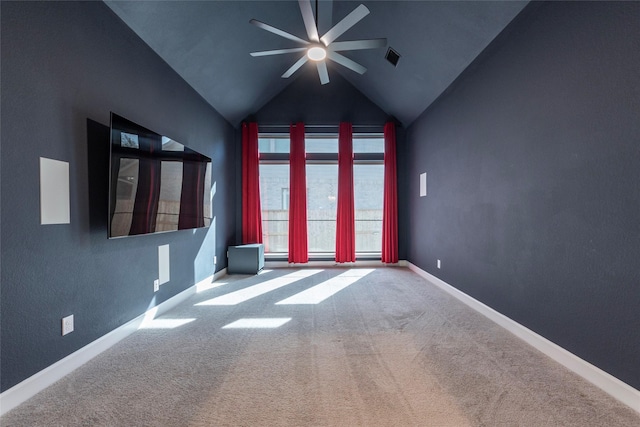 spare room with ceiling fan, carpet, and vaulted ceiling