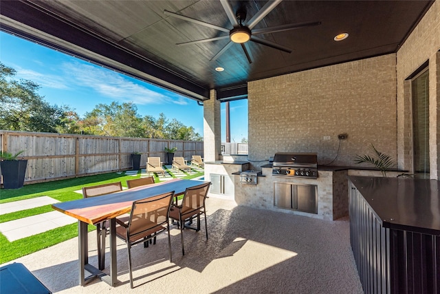 view of patio / terrace featuring ceiling fan, exterior kitchen, and grilling area