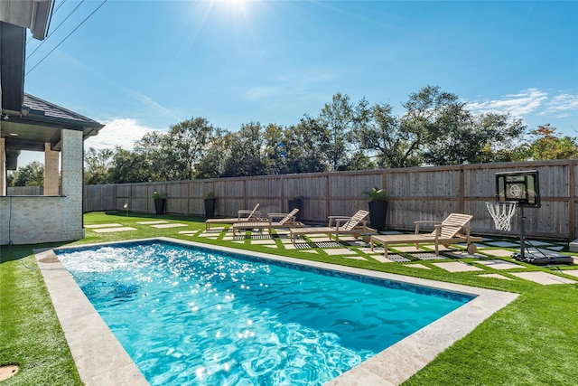 view of pool with a lawn and a patio area