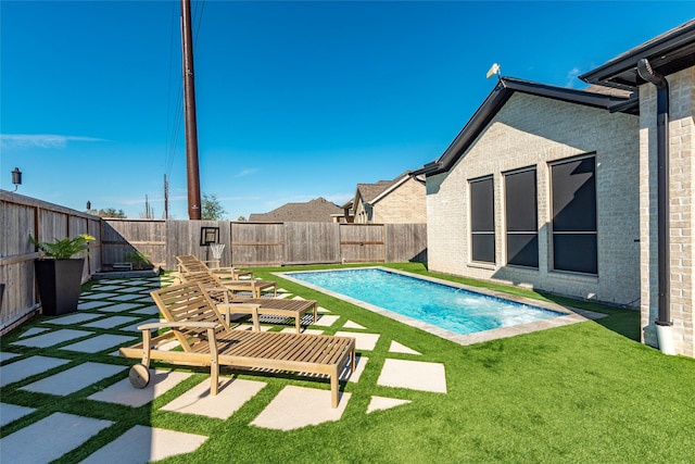 view of pool featuring a lawn