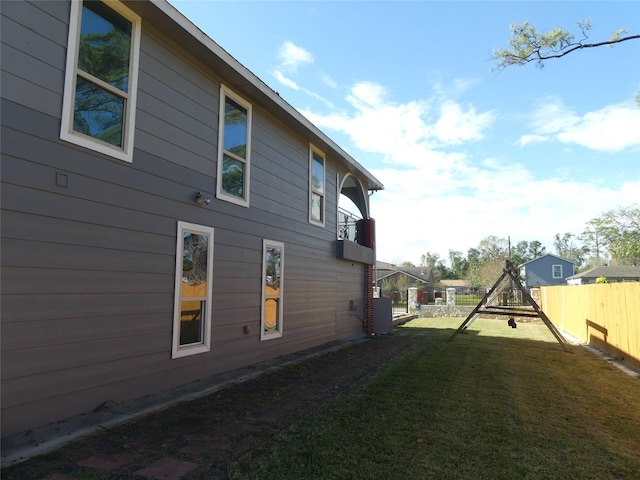 view of side of property with cooling unit and a yard