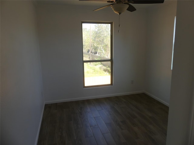 empty room with ceiling fan and dark wood-type flooring