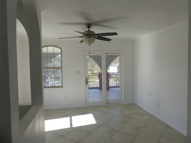 tiled spare room featuring ceiling fan and ornamental molding