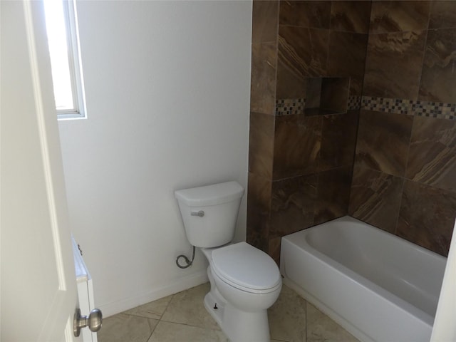 bathroom with tile patterned floors, tiled shower / bath, and toilet