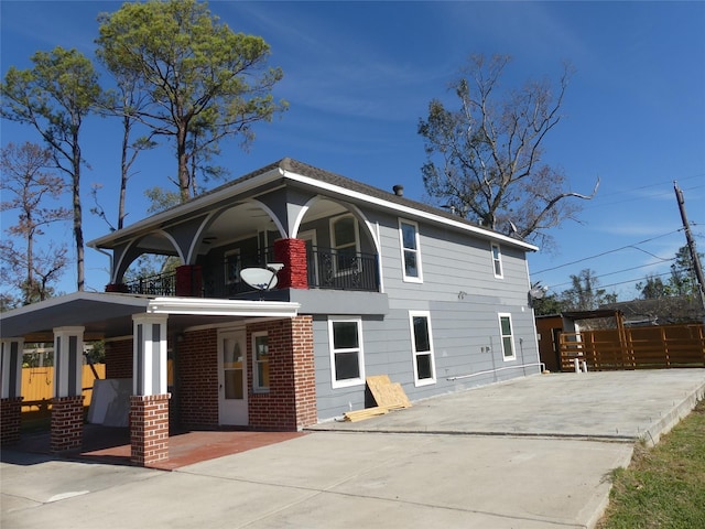 rear view of house featuring a balcony