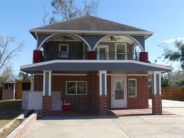 view of front of property featuring ceiling fan, a balcony, and covered porch