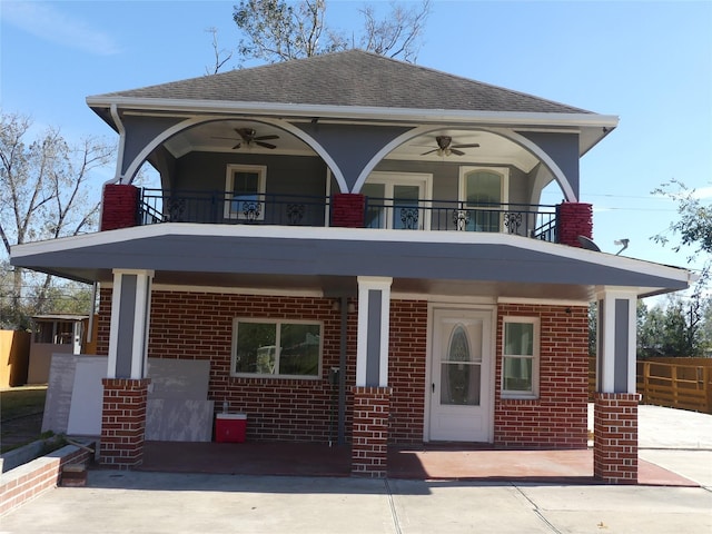 view of front of house with a balcony and ceiling fan