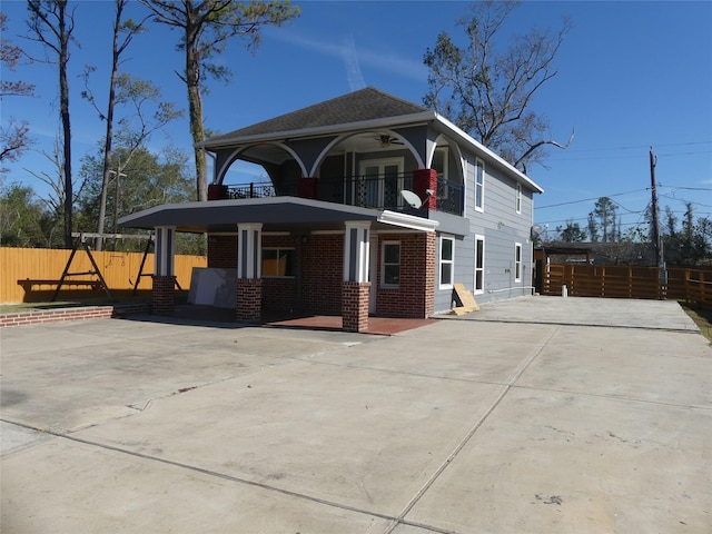 exterior space featuring ceiling fan and a balcony