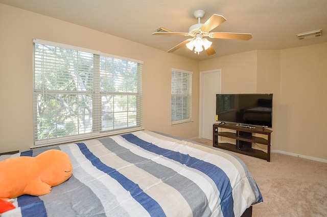 bedroom with ceiling fan and light colored carpet