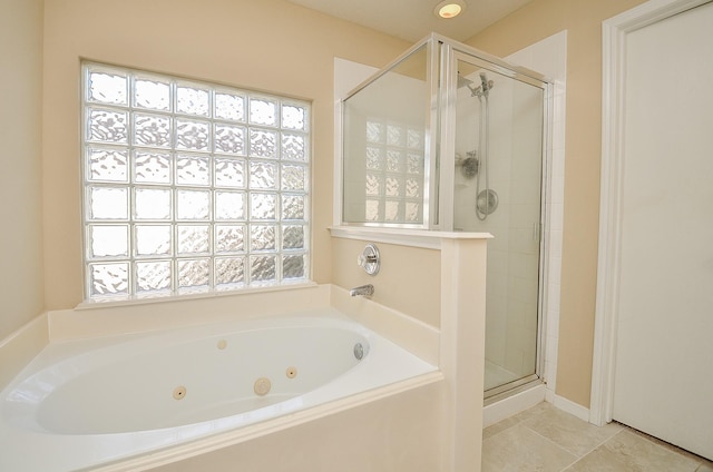 bathroom with tile patterned floors and independent shower and bath