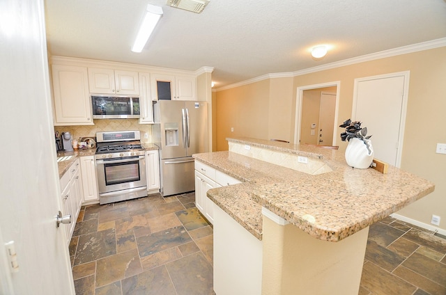 kitchen with decorative backsplash, ornamental molding, light stone counters, white cabinetry, and stainless steel appliances