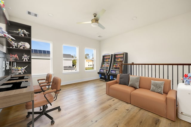 office with ceiling fan and light hardwood / wood-style floors