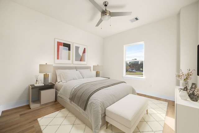 bedroom with light hardwood / wood-style flooring and ceiling fan