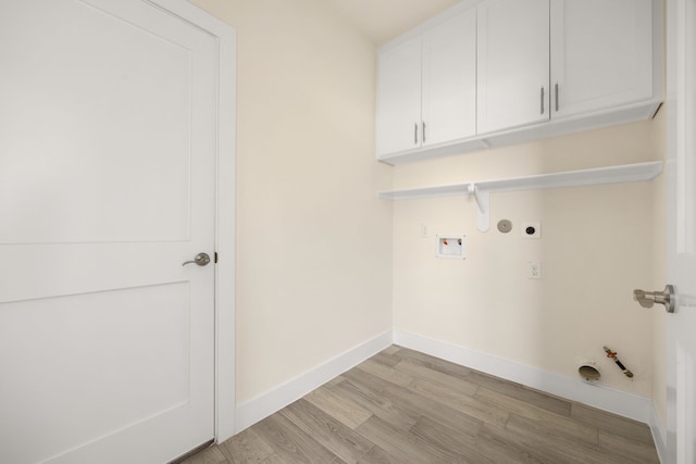 laundry room with cabinets, washer hookup, electric dryer hookup, hookup for a gas dryer, and light hardwood / wood-style flooring