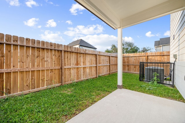 view of yard featuring central AC unit and a patio