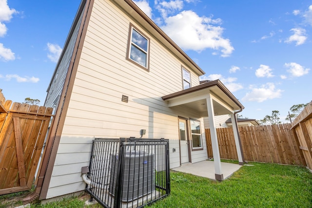 back of property featuring a yard, a patio, and central AC unit