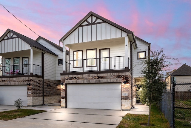 view of front facade with a garage and a balcony