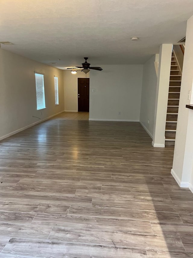 interior space with ceiling fan and hardwood / wood-style flooring