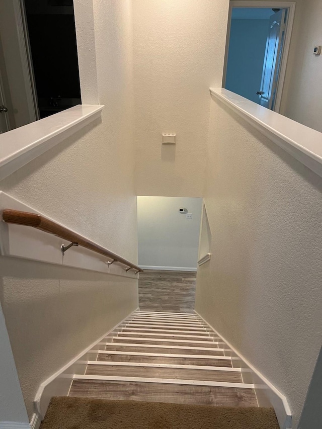 staircase featuring hardwood / wood-style flooring