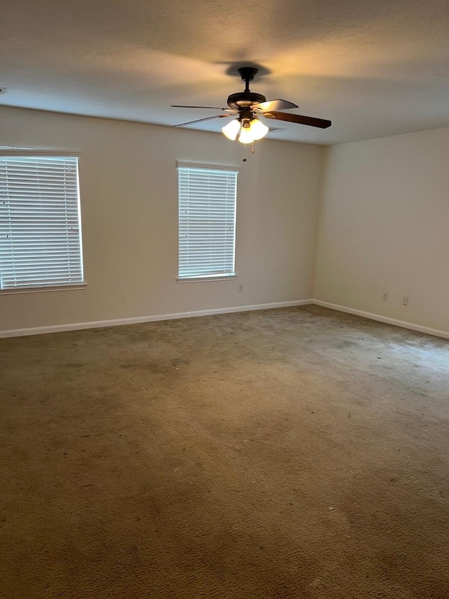 empty room with carpet flooring and ceiling fan