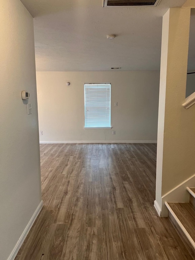 spare room with dark wood-type flooring