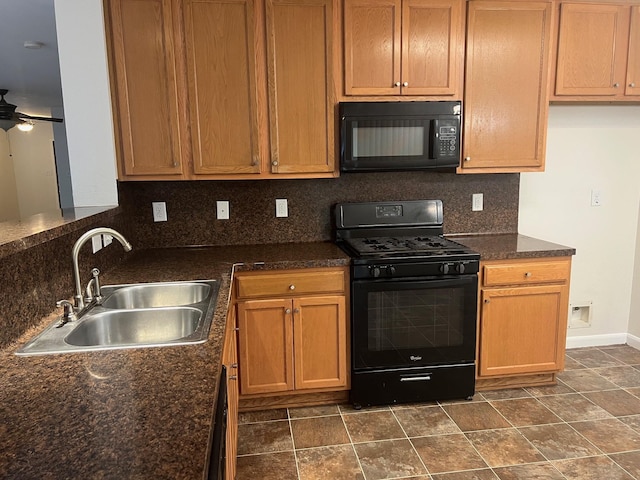 kitchen with backsplash, dark stone counters, black appliances, sink, and ceiling fan