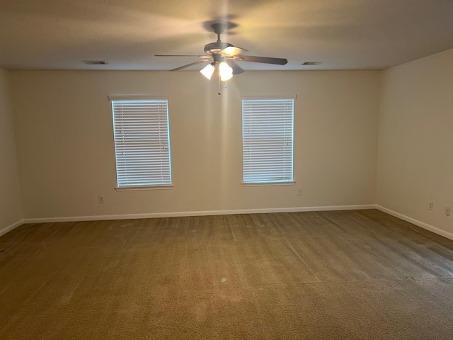 spare room with carpet flooring and ceiling fan