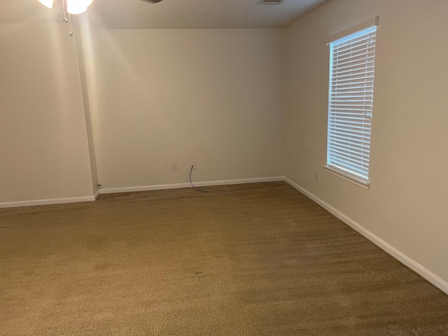 carpeted spare room with ceiling fan