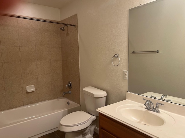 full bathroom featuring vanity, toilet, and tiled shower / bath