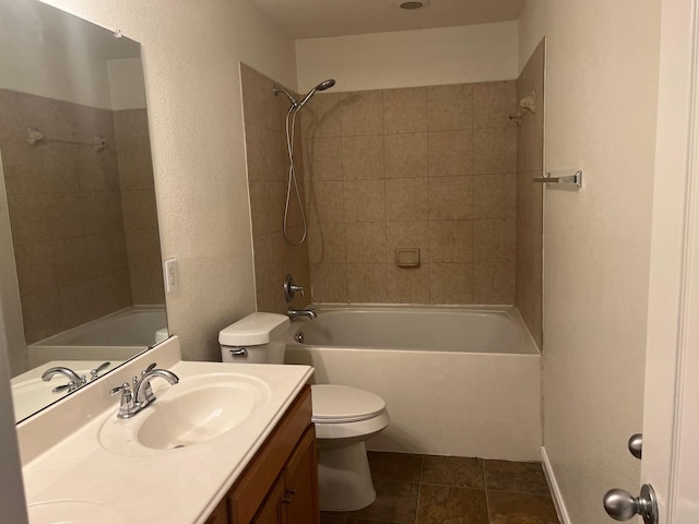 full bathroom with toilet, tile patterned flooring, vanity, and tiled shower / bath