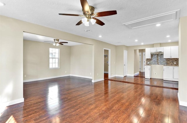 unfurnished living room featuring a textured ceiling, dark hardwood / wood-style flooring, and ceiling fan