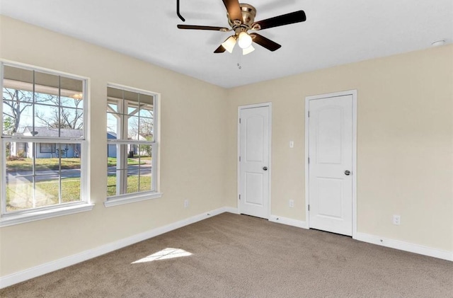 spare room featuring carpet flooring and ceiling fan