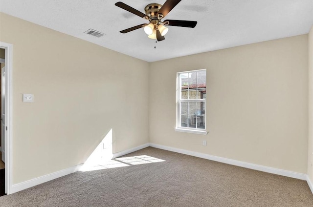 carpeted spare room with ceiling fan