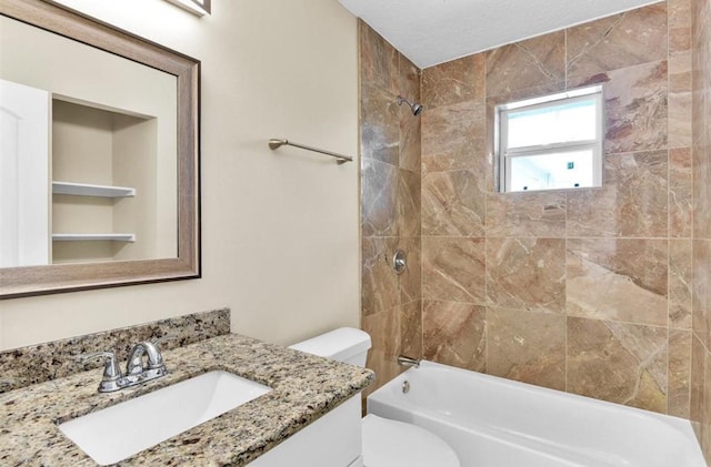 full bathroom featuring vanity, toilet, and tiled shower / bath