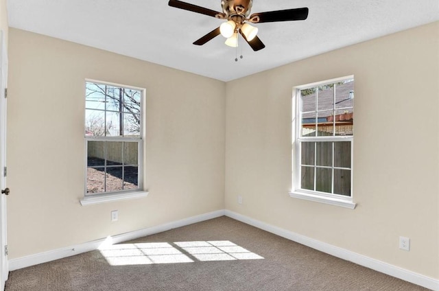 empty room with ceiling fan and light colored carpet